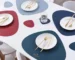Elegant leather placemats set on a dining table with coasters