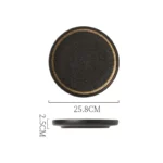 Black dinner plate with quicksand texture on a wooden table