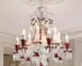 Modern red crystal chandelier with clear red K9 crystals hanging in a living room