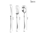 Elegant French stainless steel cutlery set with pointed tail handles on a wooden table