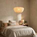 Wabi sabi pendant light hanging over a wooden dining table in a cozy room