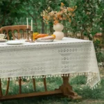Retro polka dot tablecloth with fringe on a wooden table