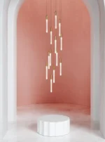The fixture lighting a hallway, with its length emphasizing the vertical space.