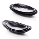 Black melamine dinner plates stacked elegantly on a wooden table