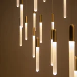 The hanging light illuminating a staircase, with the fixture centered over the steps.