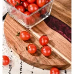 Round acacia cutting board with resin inlay on kitchen counter