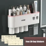 Side view of toothpaste dispenser and toothbrush holder set, with cups and rack in a tiled bathroom.
