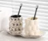 Luxury electroplated ceramic mug set for couples, two toothbrush cups in metallic finish on bathroom counter.