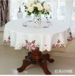 Elegant lace tablecloth with rose gold embroidery on a dining table