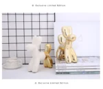 Balloon dog saving pot on a dresser with a mirror and jewelry box.
