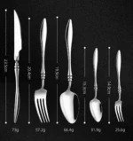 Elegant French stainless steel cutlery set with pointed tail handles on a wooden table