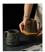 Vintage ceramic coffee mug with underglaze floral pattern on wooden table