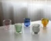 Clear double wall insulated glass mug with espresso coffee on wooden table