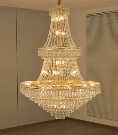 Modern crystal chandelier for dining room hanging over a wooden table with warm glow