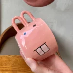 Funny pig teapot pouring tea from its snout on a kitchen counter