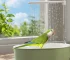 Colorful parrot enjoying a parrot shower bath in a white bird bathtub accessory