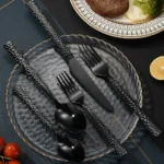Elegant stainless steel flatware set with hammered finish on wooden table