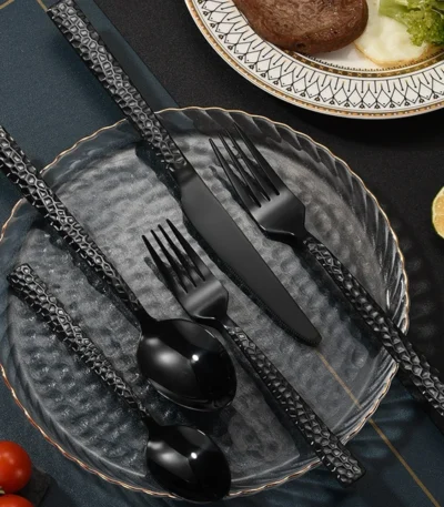 Elegant stainless steel flatware set with hammered finish on wooden table