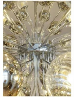 Smoky gray chandelier with glass bubbles hanging over a modern dining table