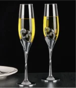 Elegant crystal champagne glasses set on a table with sparkling wine