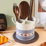 4-grid iron kitchen utensil storage box with chopsticks, spoons, and forks neatly organized on a countertop