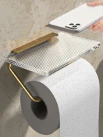 The aluminum alloy toilet paper holder shown on a wooden wall, empty acrylic tray visible.