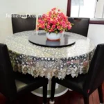 Elegant lace tablecloth with rose gold embroidery on a dining table