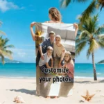 Custom photo beach towel with a vibrant family photo, lying on the sand near the ocean