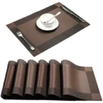 Gold weave placemats on a dining table with plates and cutlery