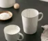 Enamel baking measuring cup with dual scale markings on a kitchen counter