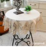 Elegant lace tablecloth with rose gold embroidery on a dining table