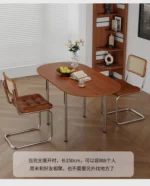 Nordic minimalist folding dining table with stainless steel telescopic extension in a modern living room setting