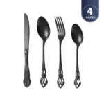 Gold flatware set with spoon, fork, and steak knife on a white tablecloth