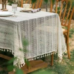 Retro polka dot tablecloth with fringe on a wooden table