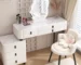 White modern vanity with stool featuring a large mirror and ample storage