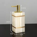 Gold toothbrush holder on marble counter, side view.