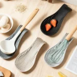 Silicone spoon rest holding a wooden spoon on a kitchen counter