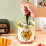 4-grid iron kitchen utensil storage box with chopsticks, spoons, and forks neatly organized on a countertop