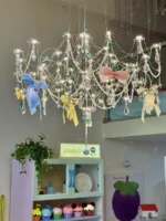 Modern stainless steel chandelier with crystal LED lights in a living room