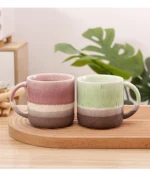 Large ceramic coffee mug with retro design and handle on wooden table