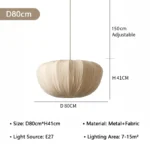 Wabi sabi pendant light hanging over a wooden dining table in a cozy room