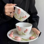 Floral coffee mug with painted flowers and European relief tulip design on ceramic