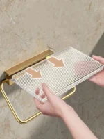Close-up of the punch-free installation kit for the aluminum alloy toilet paper holder on a tiled wall.
