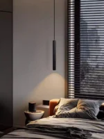 Modern pendant light with double cylindrical shades in a Nordic dining room setting