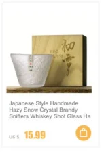 Set of hazy wine glasses with hammer pattern and snowflake design on a wooden table