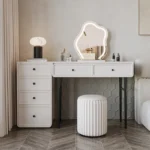 Modern minimalist makeup vanity table with mirror and stool in a bedroom setting
