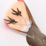 Close-up of a simulation bird's textured foam body and painted eyes, emphasizing realistic craftsmanship.