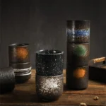 Japanese ceramic beer mug filled with amber ale, showcasing traditional glaze and ergonomic handle