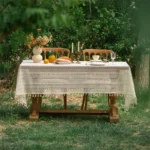 Retro polka dot tablecloth with fringe on a wooden table