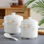 Ceramic stew pot with double lid in bird's nest design on wooden table